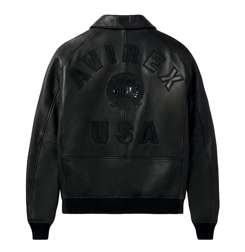 OFFCODE.USA black leather bomber jacket with "AVIREX USA" logo detail on back. Ribbed hem and cuffs.