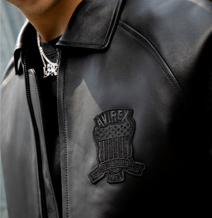 OFFCODE.USA Avirex black lamb leather bomber jacket with embroidered logo patch on chest. Features zip front.
