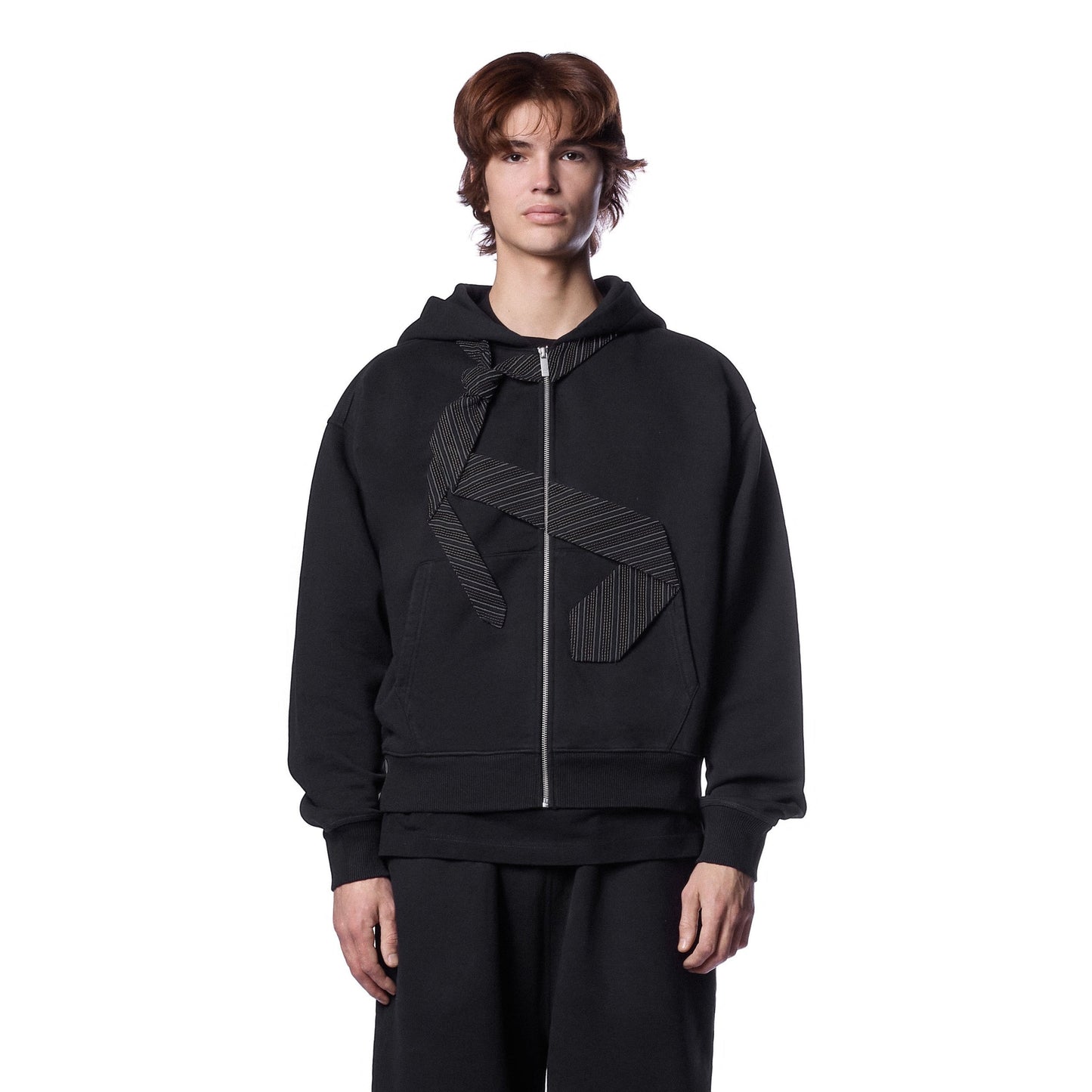 OFFCODE.USA black cotton zip-up hoodie with embroidered tie patch on front and back. Model wearing size L.