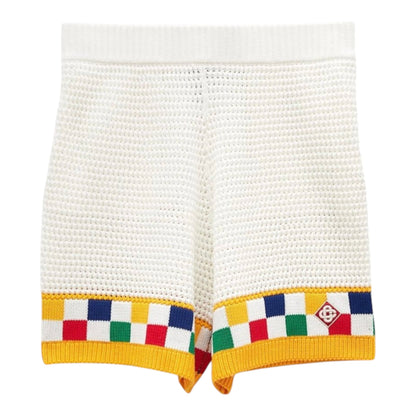 OFFCODE.USA Casablanca Faux Crochet Shorts in white with yellow trim and a colorful checkered pattern.