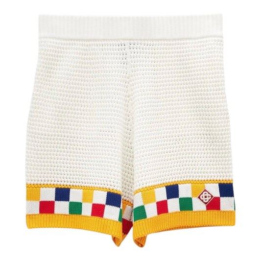 OFFCODE.USA Casablanca Faux Crochet Shorts in white with yellow trim and a colorful checkered pattern.