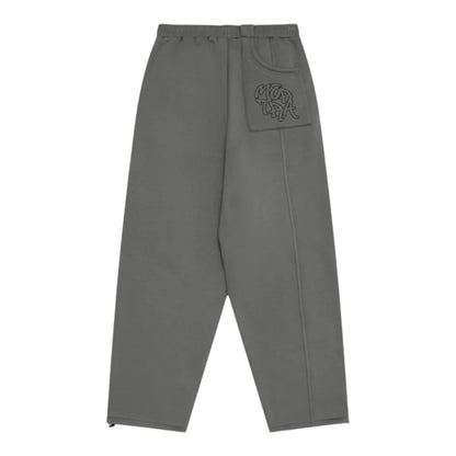 OFFCODE.USA charcoal grey cotton blend joggers with embroidered graphics on pocket and signature paneling. Wide leg fit.