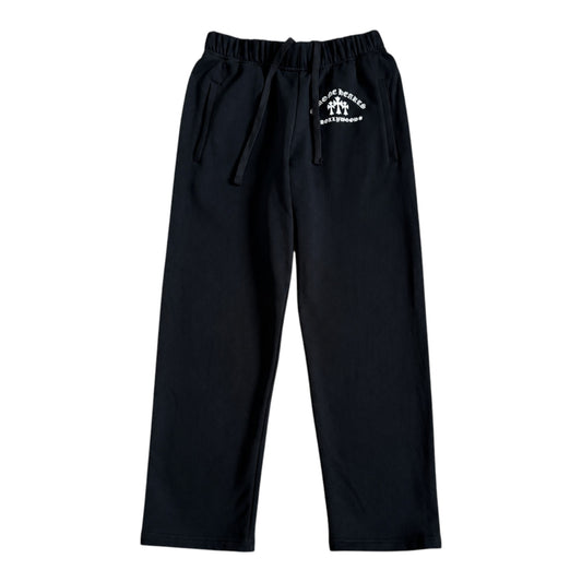 OFFCODE.USA black Chrome Hearts King Taco sweatpants featuring white triple cross embroidery and an elastic waistband.