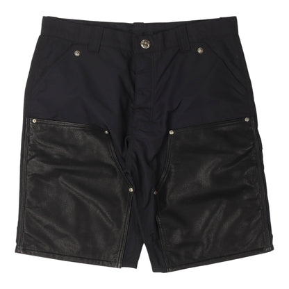 OFFCODE.USA Chrome Hearts black nylon carpenter shorts featuring leather double knee panels and silver hardware.