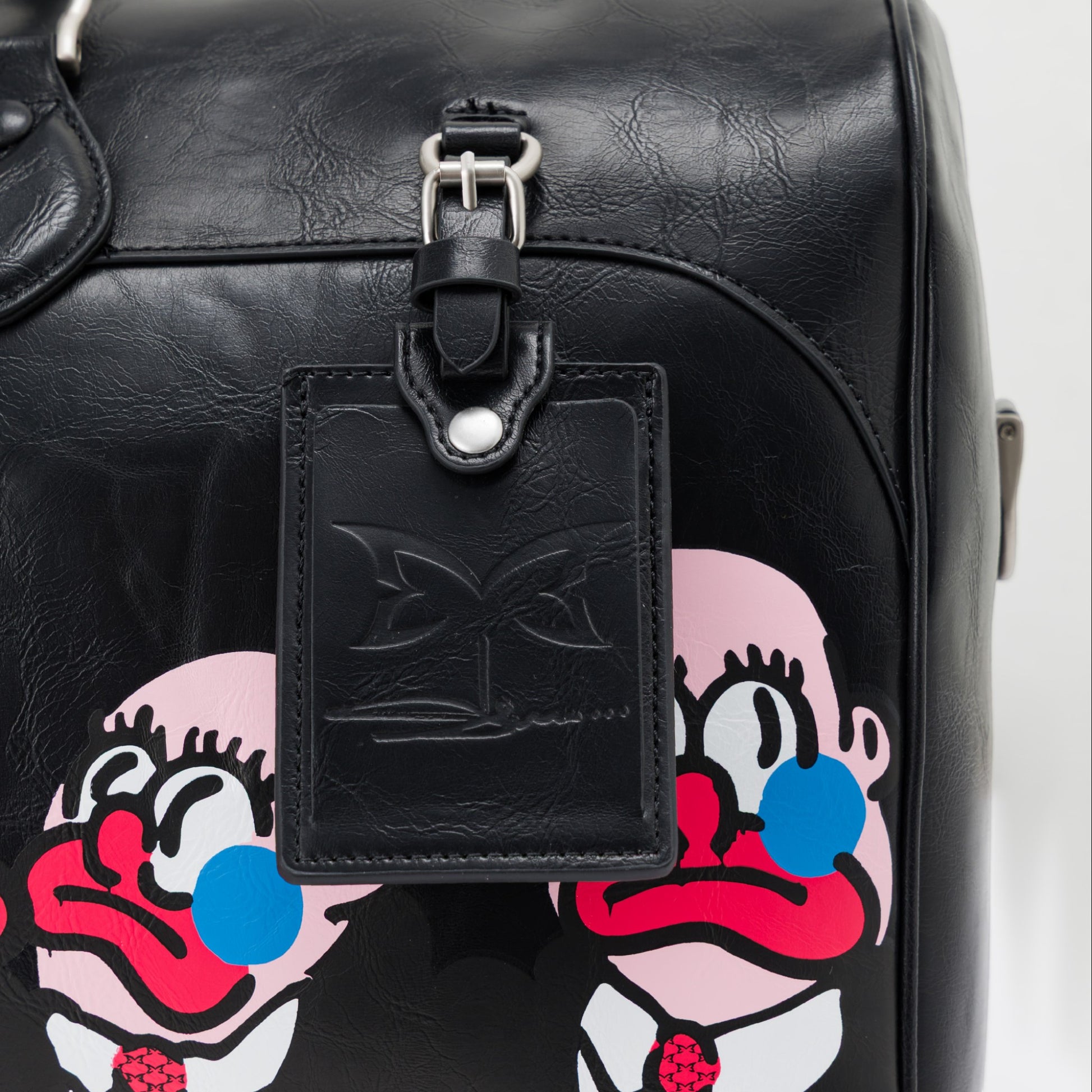 OFFCODE.USA MERTRA x Slawn Duffle bag in black PU leather with Olaolu Slawn artwork graphics and debossed details.