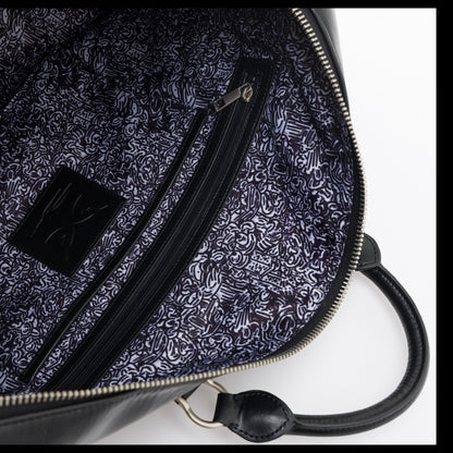 OFFCODE.USA MERTRA x Slawn Duffle bag interior with Olaolu Slawn artwork lining, PU leather shell, and interior pockets.