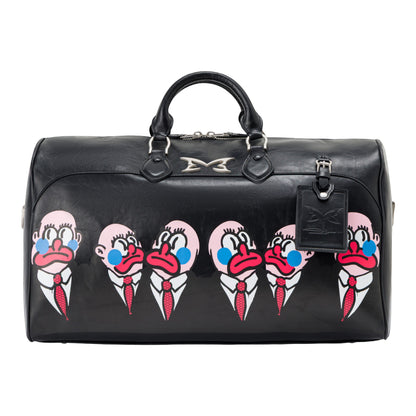 OFFCODE.USA MERTRA x Slawn Duffle bag in black PU leather with graphic print of cartoon faces. Features carry handles and detachable strap.