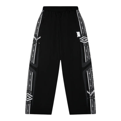 OFFCODE.USA MERTRA x Umbro technical track pants in black with white Umbro tape detailing and logo accents.