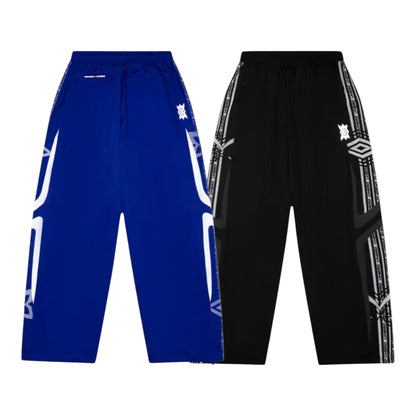 OFFCODE.USA MERTRA x Umbro technical track pants in blue and black with graphic side stripes and logos.