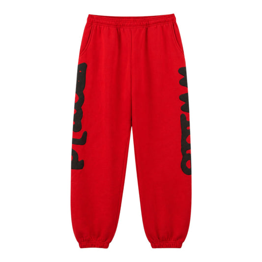 OFFCODE.USA red imitation cotton jogger pants with black Sp5der print on legs, drawstring waist, and elastic cuffs.