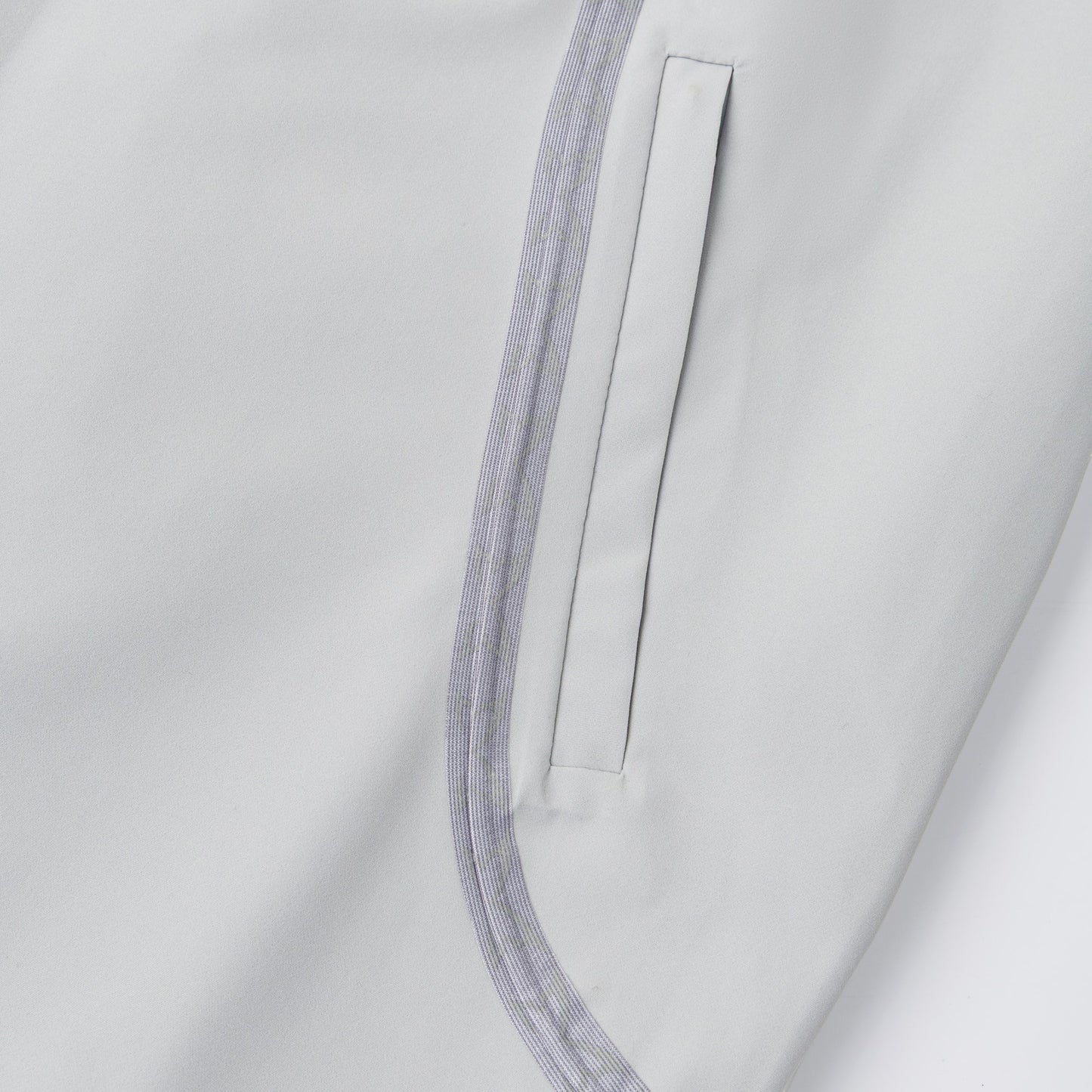OFFCODE.USA Seam Tape Jacket in light grey polyamide with glow-in-the-dark monogram logos on taping and embroidered sleeve detail.