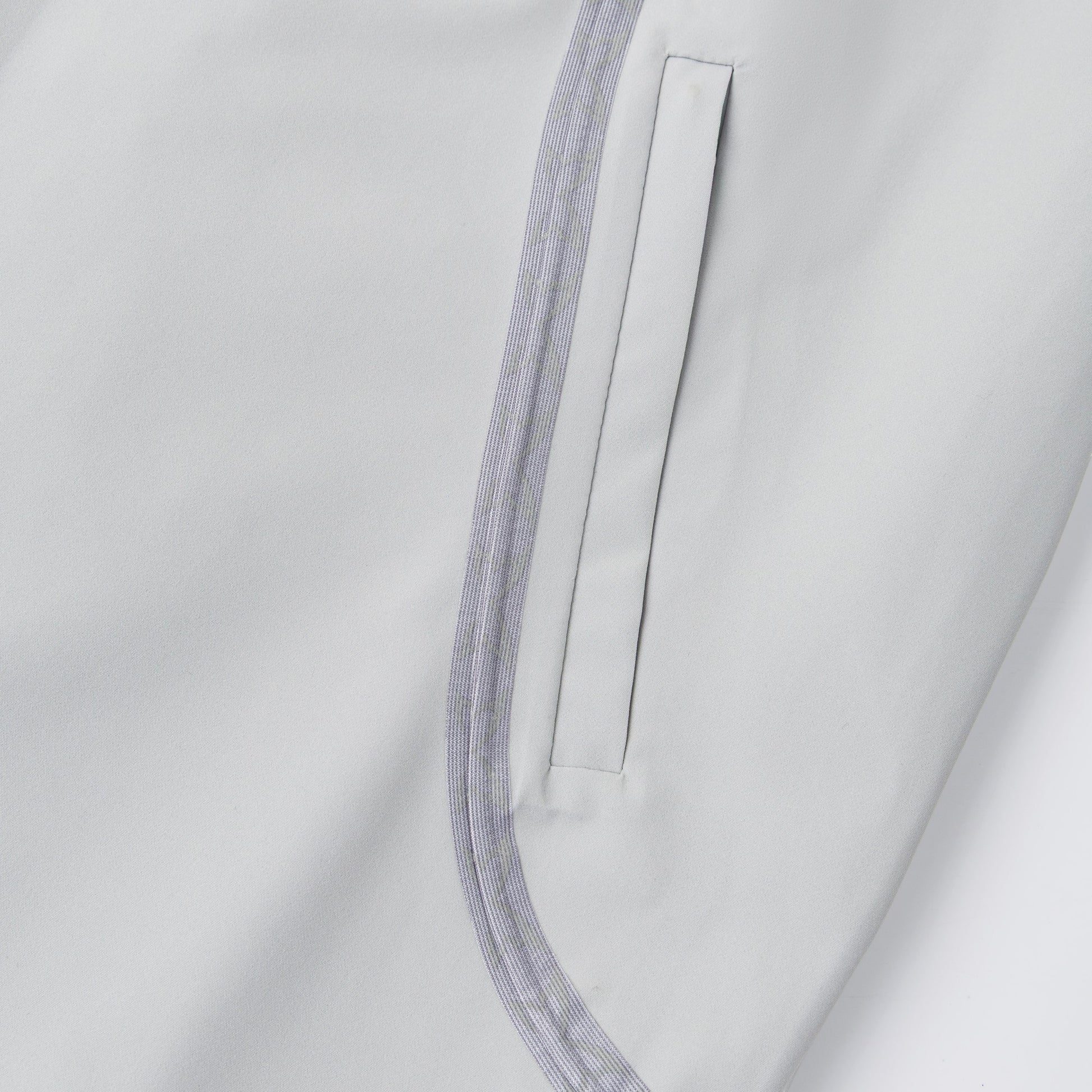 OFFCODE.USA Seam Tape Jacket in light grey polyamide with glow-in-the-dark monogram logos on taping and embroidered sleeve detail.