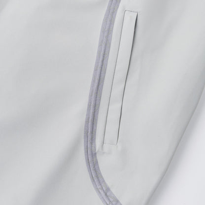 OFFCODE.USA Seam Tape Jacket in light grey polyamide with glow-in-the-dark monogram logos on taping and embroidered sleeve detail.