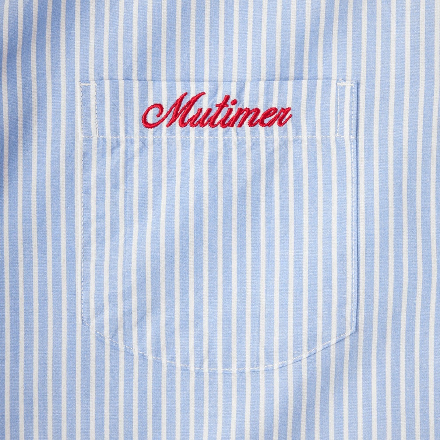 OFFCODE.USA blue and white striped cotton work shirt with red embroidered 'Mutimer' on chest pocket.