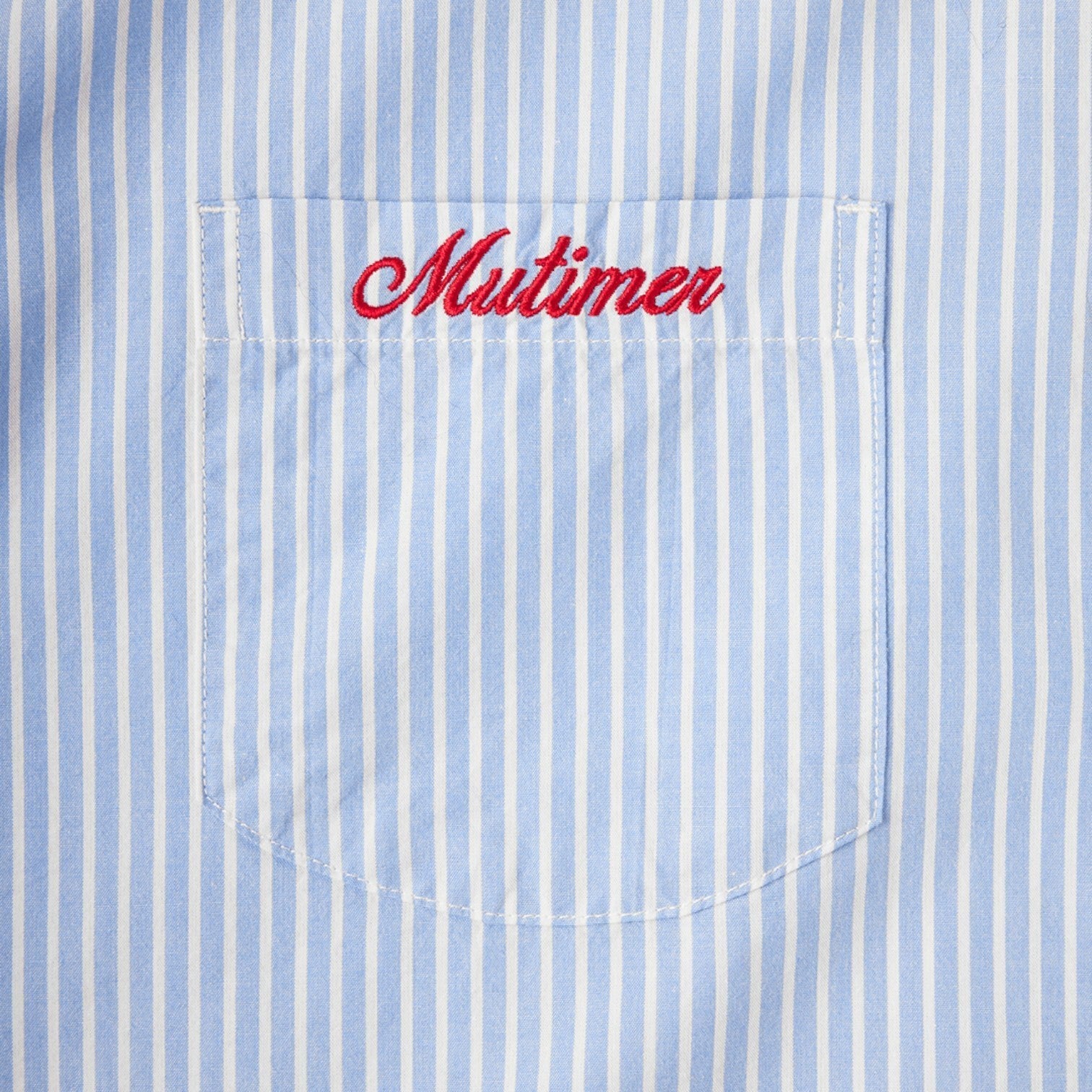 OFFCODE.USA blue and white striped cotton work shirt with red embroidered 'Mutimer' on chest pocket.
