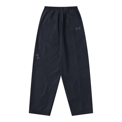 OFFCODE.USA black tech joggers with reflective logos, asymmetrical paneling, and wide leg fit.