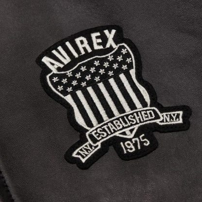 OFFCODE.USA Trapstar X Avirex Icon Leather Jacket - Black. Features embroidered shield patch with "AVIREX ESTABLISHED 1975 NY".