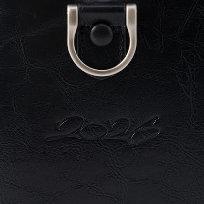 OFFCODE.USA MERTRA x Slawn Duffle bag in black PU leather with debossed graphics and metal hardware.
