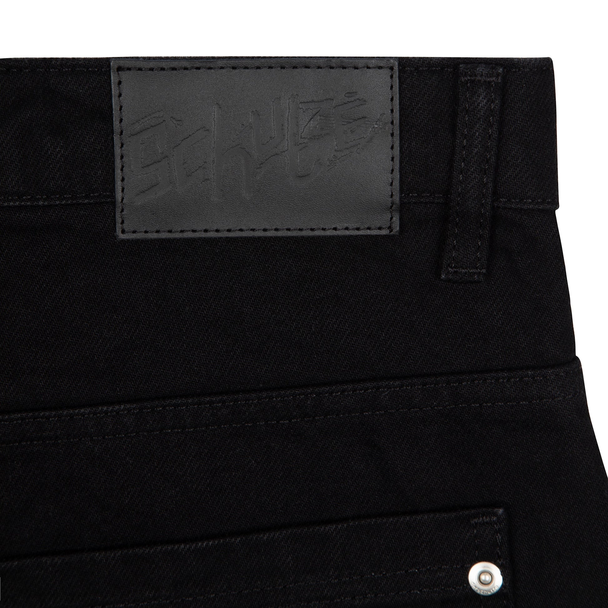 OFFCODE.USA black denim jeans with balloon fit, 100% cotton, featuring a black leather patch with embossed logo.