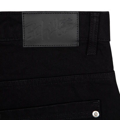 OFFCODE.USA black denim jeans with balloon fit, 100% cotton, featuring a black leather patch with embossed logo.
