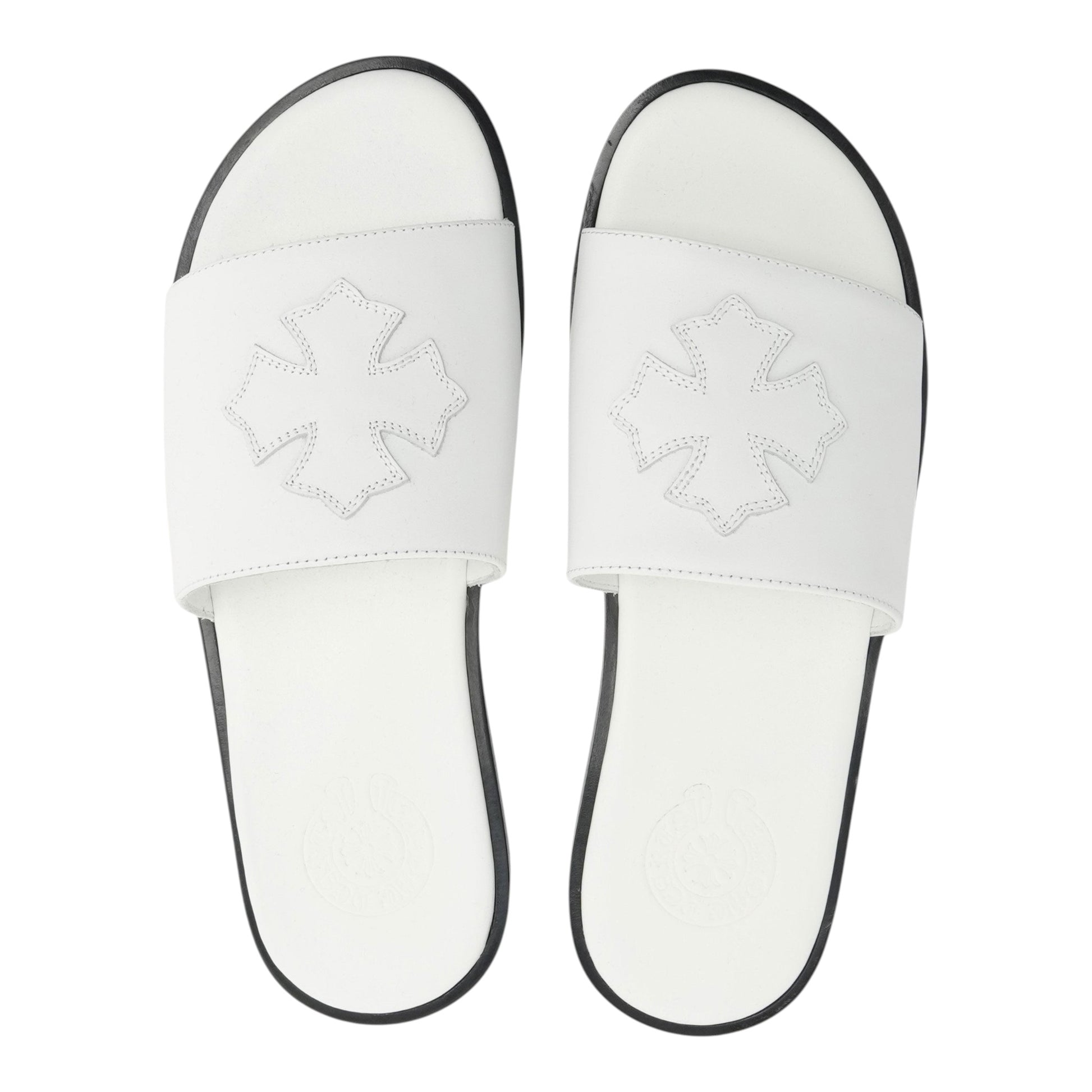 OFFCODE.USA white leather slides featuring a decorative cross patch on the strap and a black sole.