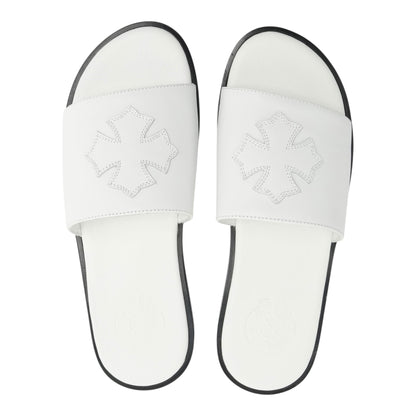 OFFCODE.USA white leather slides featuring a decorative cross patch on the strap and a black sole.