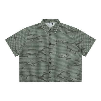 OFFCODE.USA green cotton grid camo print short sleeve shirt with embroidered logos and tortoise shell buttons.