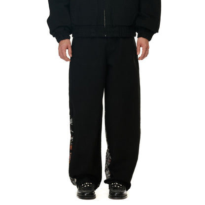 OFFCODE.USA black denim balloon fit jeans with intricate embroidery on the side seams. Made from 100% cotton.