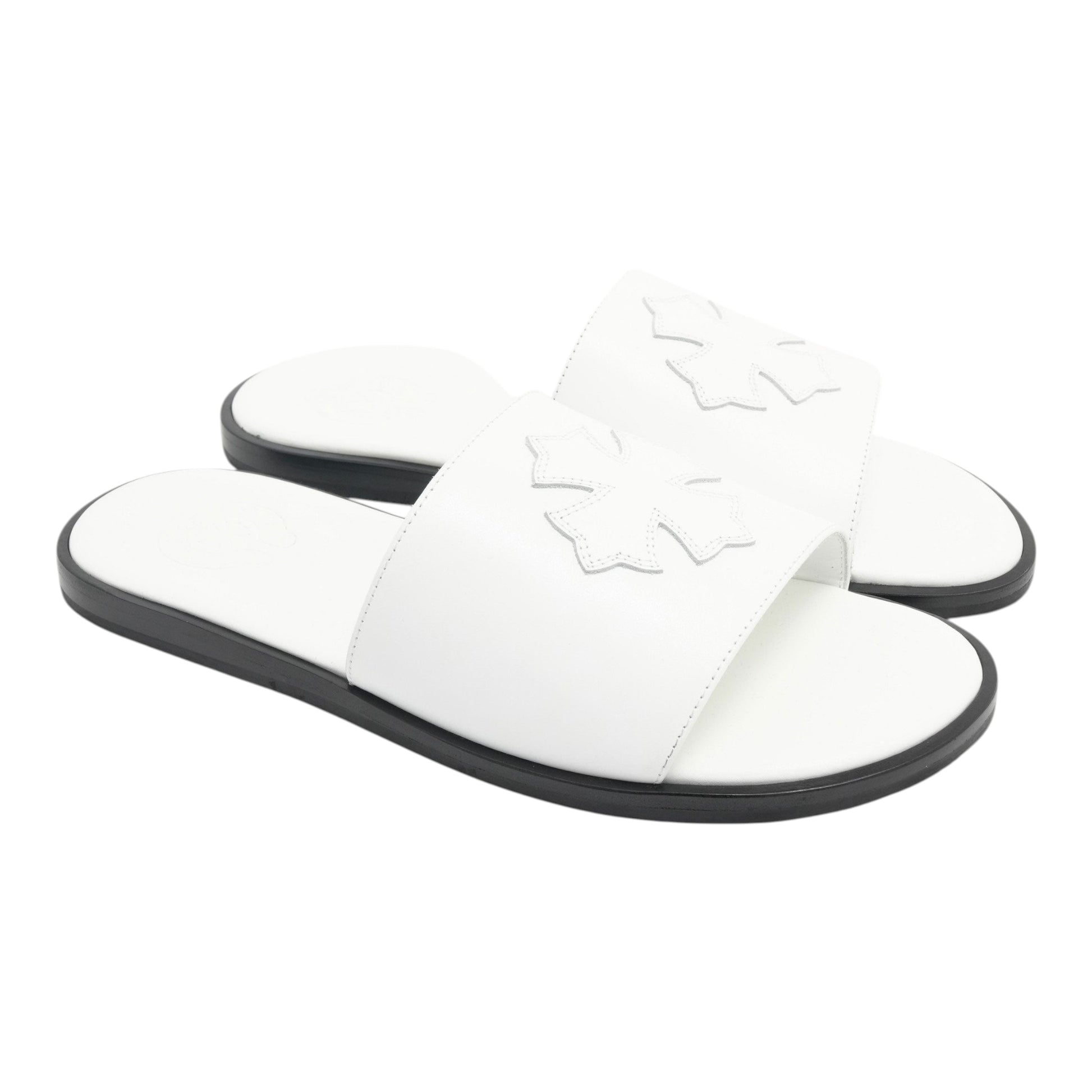 OFFCODE.USA white leather slides featuring a decorative cross patch detail on the strap and a black sole.