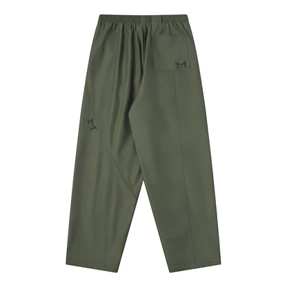 OFFCODE.USA olive green tech joggers with asymmetrical paneling, reflective logos, and wide leg fit.