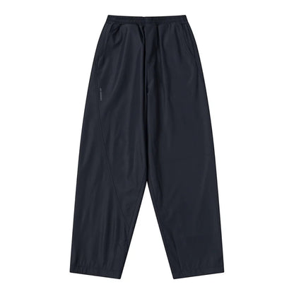 OFFCODE.USA dark navy tech joggers with asymmetrical paneling, reflective logos, and wide leg fit.