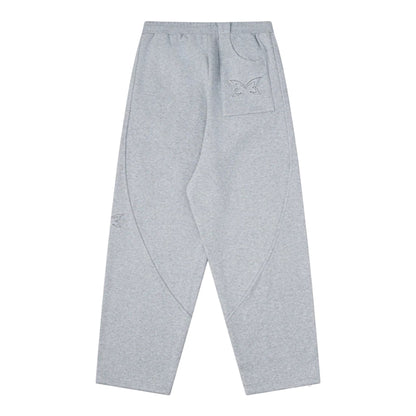 OFFCODE.USA grey cotton blend dual panel joggers with embroidered butterfly logo on back pocket.