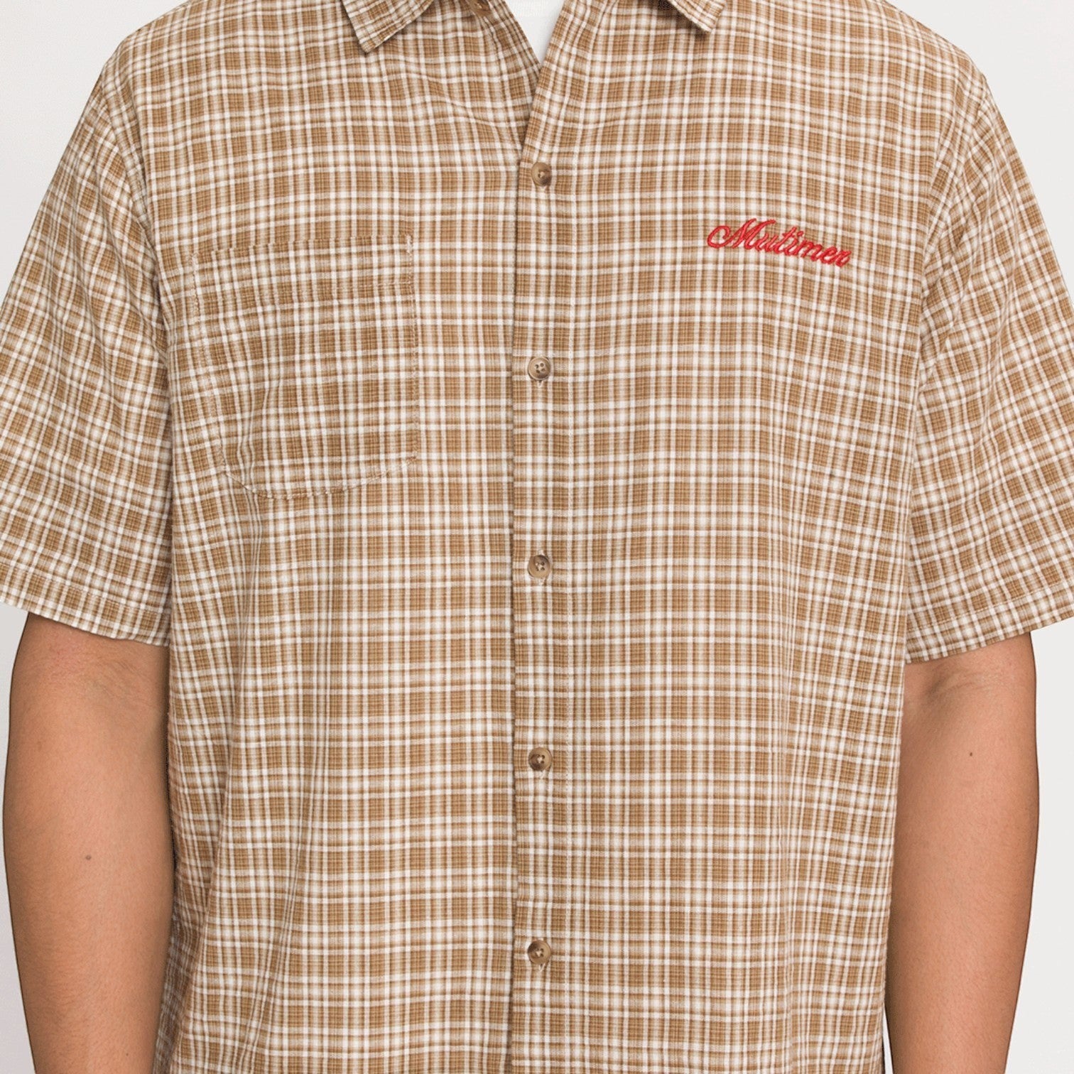 OFFCODE.USA brown and white plaid short-sleeve button-up shirt with red embroidered logo on chest.