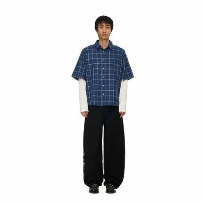 OFFCODE.USA black denim jeans with intricate embroidery and balloon fit, worn by a male model.