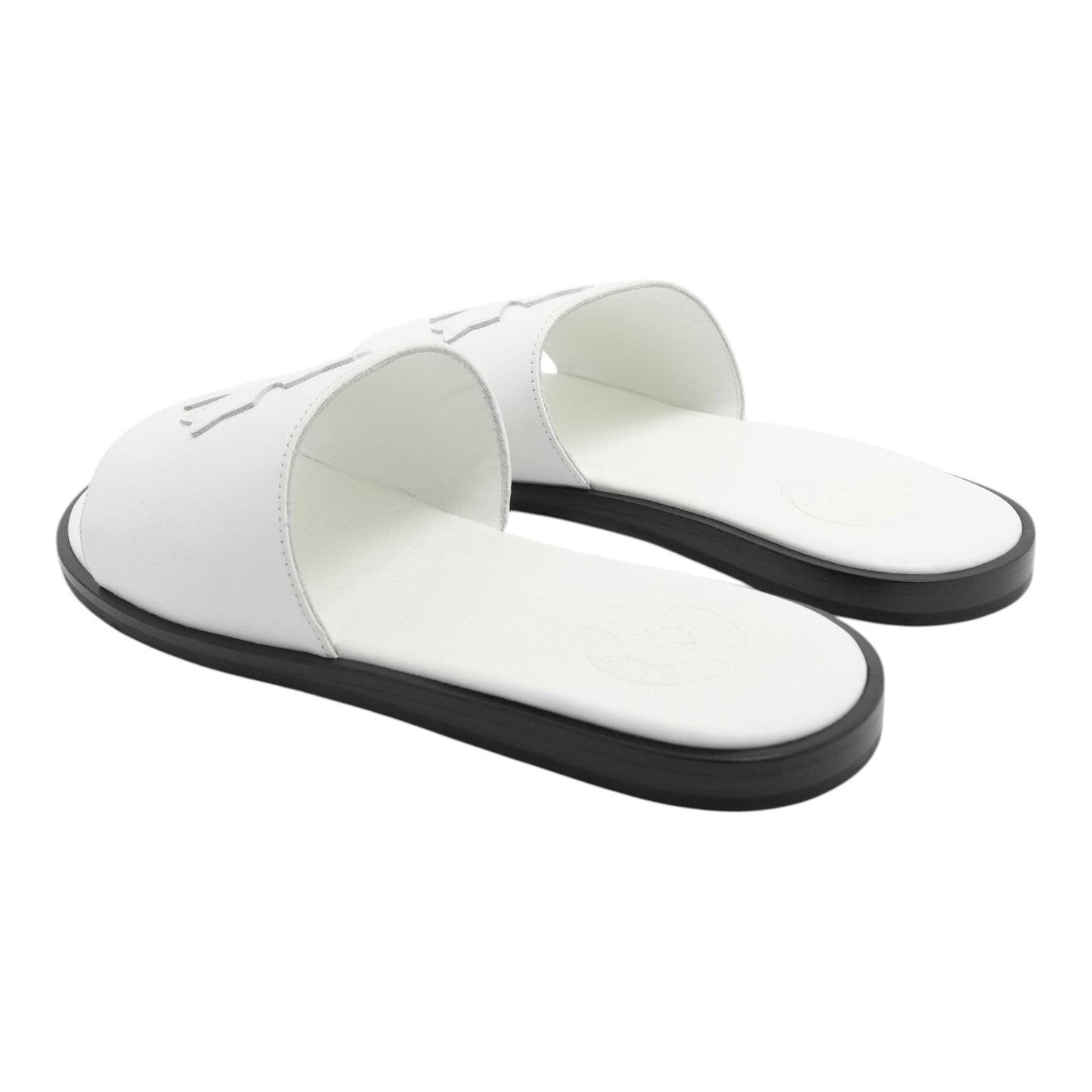 OFFCODE.USA white leather slides featuring a cross patch design and a contrasting black sole.