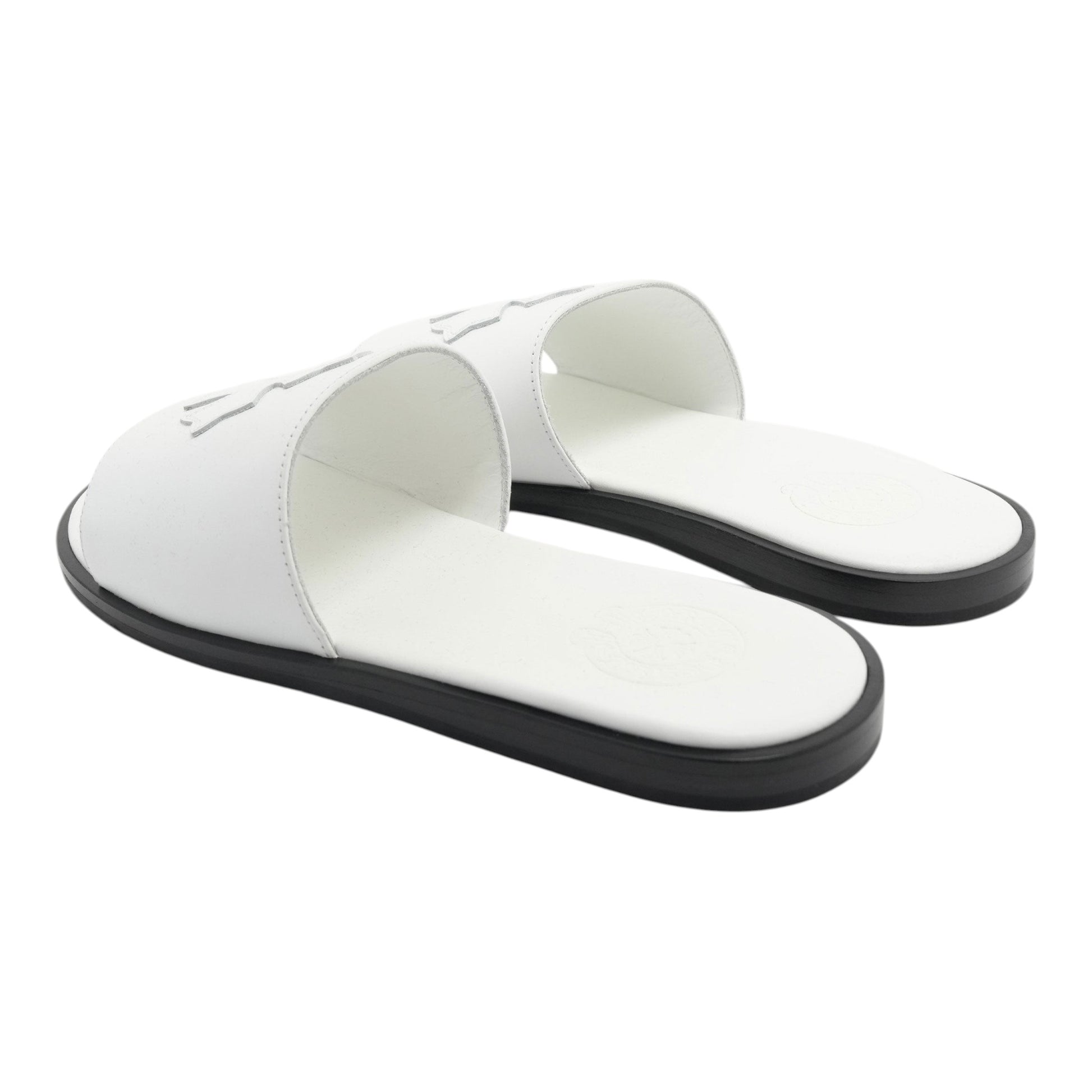 OFFCODE.USA white leather slides featuring a cross patch design and a contrasting black sole.