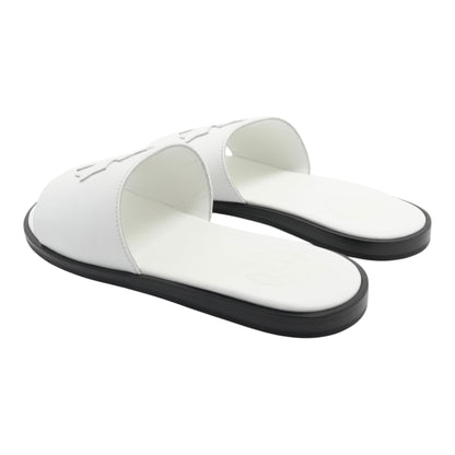 OFFCODE.USA white leather slides featuring a cross patch design and a contrasting black sole.