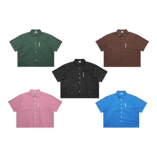OFFCODE.USA plaid shirt in green, brown, black, pink, and blue. 100% cotton with boxy cropped fit, embroidered front graphic, and tortoise shell buttons.