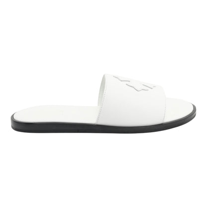 OFFCODE.USA white leather slides featuring a cross patch design and a contrasting black sole for a modern look.